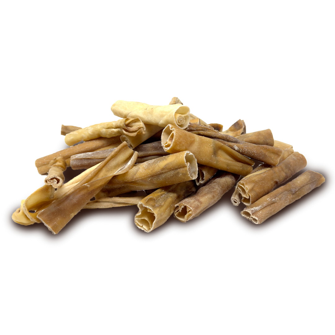 A pile of natural dried lamb skin chew sticks, displayed on a clean white background.